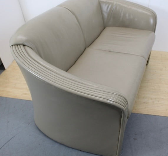 Beige leather loveseat